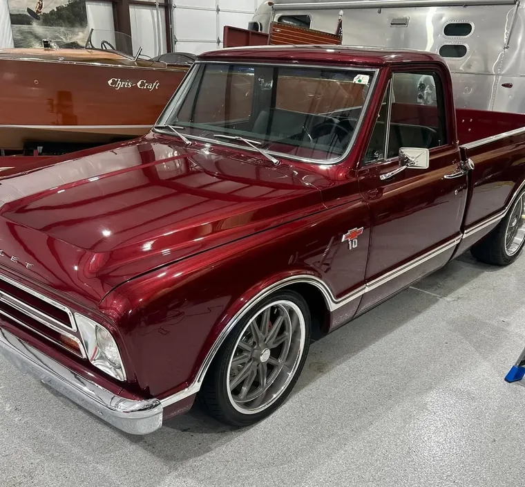 Detailed maroon Chevrolet C10 pickup in a shop