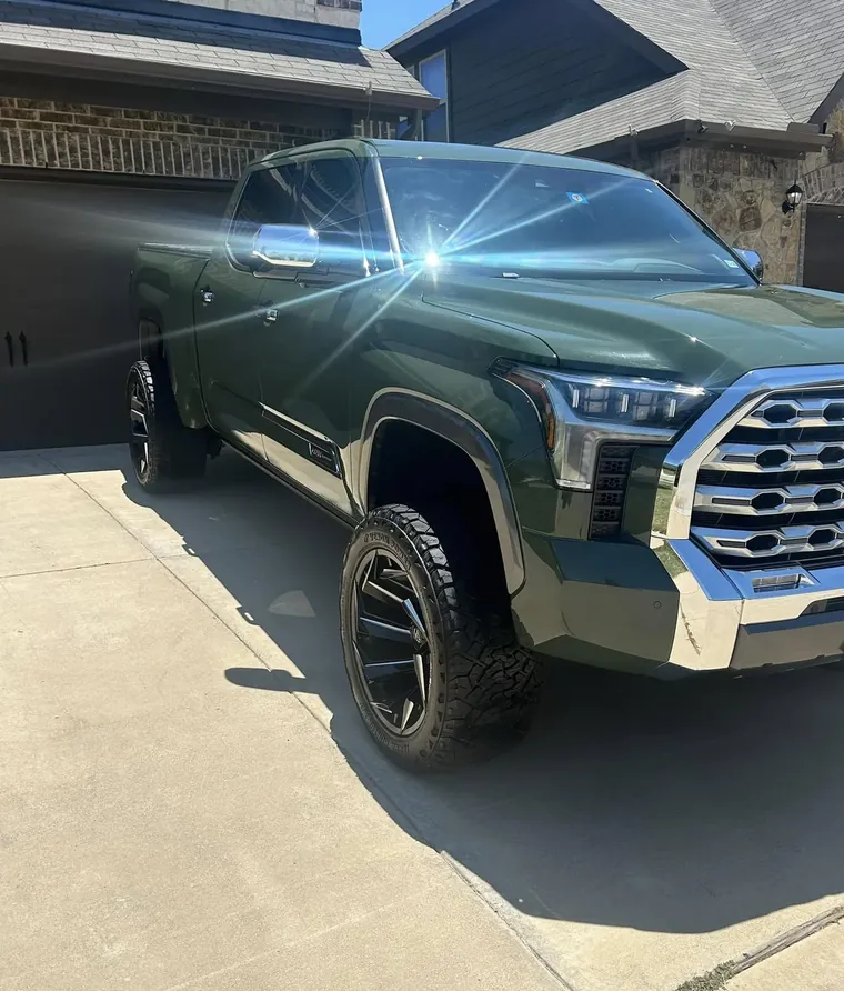 Lifted green Toyota Tundra, front three-quarter view